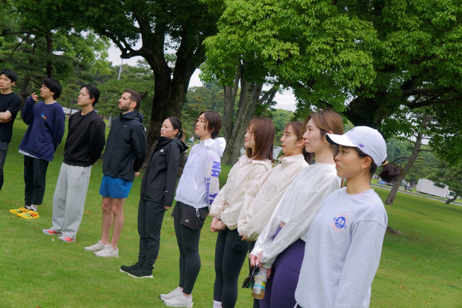Runners listening together under trees